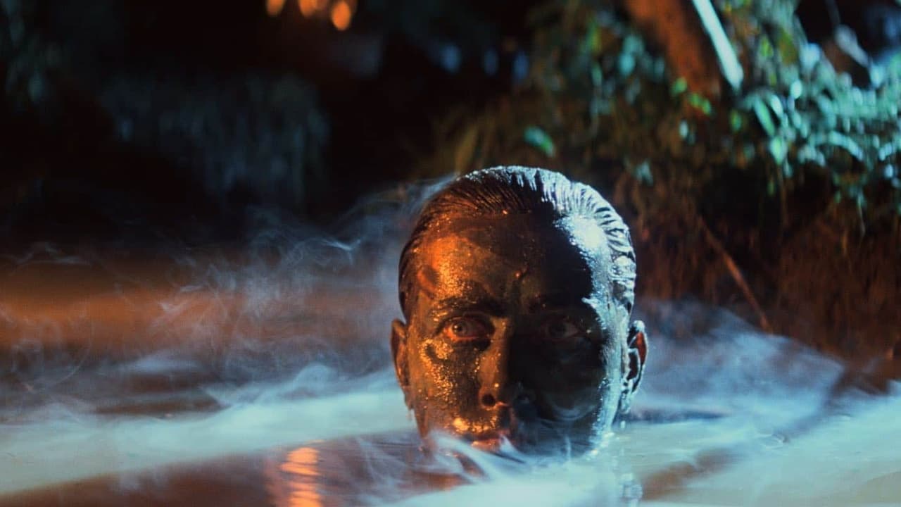 Face emerging from blue water with warm light and foliage behind